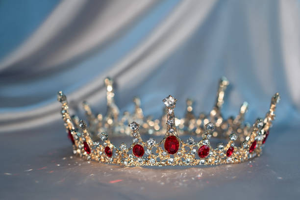 istock Sparkle royal golden crown with red gemstones 2203213477