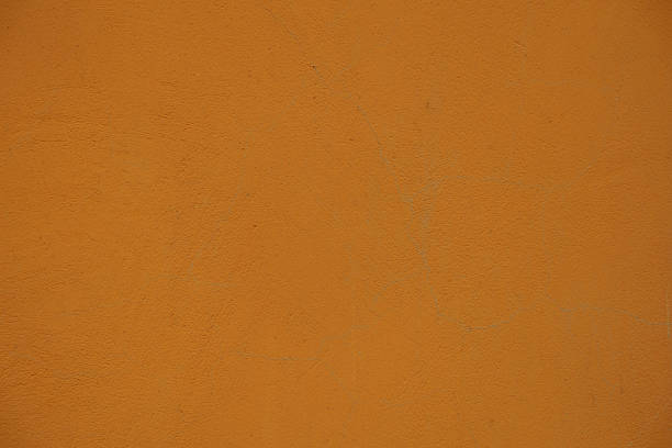 istock Macro of bright orange painted wall 2203213563