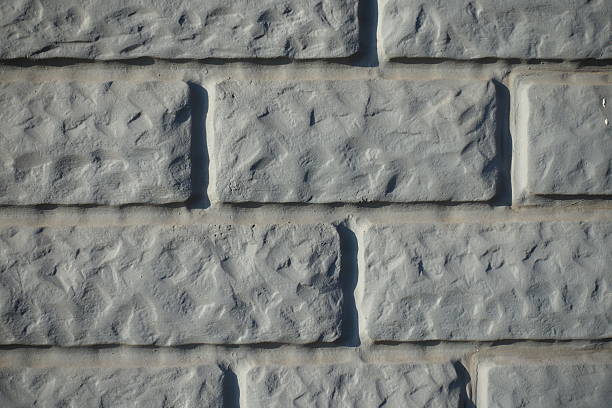 Macro of Light grey painted brick veneer wall