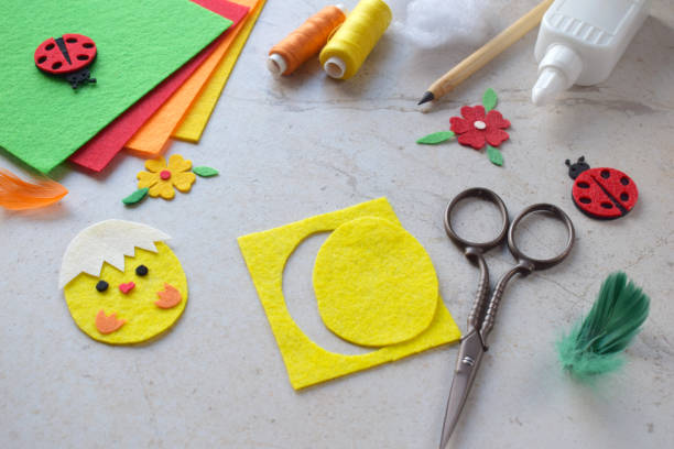 istock Handmade Felt Easter Chick. DIY Spring Craft Project with Colorful Supplies, Sewing Materials, Scissors, and Festive Decorations for Creative Fun, Kids and Hobby Enthusiasts 2203216984