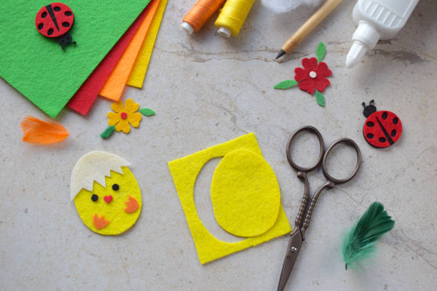istock Handmade Felt Easter Chick. DIY Spring Craft Project with Colorful Supplies, Sewing Materials, Scissors, and Festive Decorations for Creative Fun, Kids and Hobby Enthusiasts 2203216987