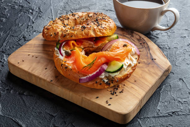 istock Lox bagel. A sandwich with smoked salmon and fresh vegetables 2203217006