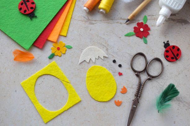 istock Handmade Felt Easter Chick. DIY Spring Craft Project with Colorful Supplies, Sewing Materials, Scissors, and Festive Decorations for Creative Fun, Kids and Hobby Enthusiasts 2203217010