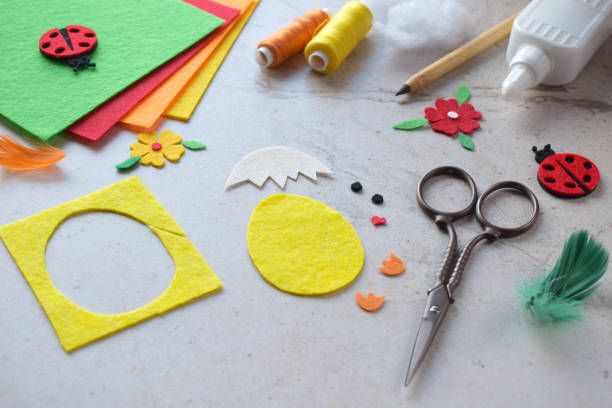 istock Handmade Felt Easter Chick. DIY Spring Craft Project with Colorful Supplies, Sewing Materials, Scissors, and Festive Decorations for Creative Fun, Kids and Hobby Enthusiasts 2203217016
