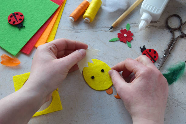 istock Handmade Felt Easter Chick. DIY Spring Craft Project with Colorful Supplies, Sewing Materials, Scissors, and Festive Decorations for Creative Fun, Kids and Hobby Enthusiasts 2203217077