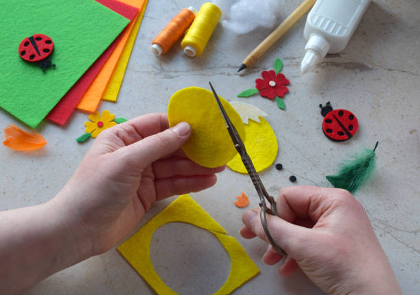 istock Handmade Felt Easter Chick. DIY Spring Craft Project with Colorful Supplies, Sewing Materials, Scissors, and Festive Decorations for Creative Fun, Kids and Hobby Enthusiasts 2203217079