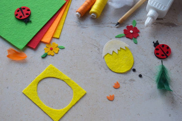 istock Handmade Felt Easter Chick. DIY Spring Craft Project with Colorful Supplies, Sewing Materials, Scissors, and Festive Decorations for Creative Fun, Kids and Hobby Enthusiasts 2203217193