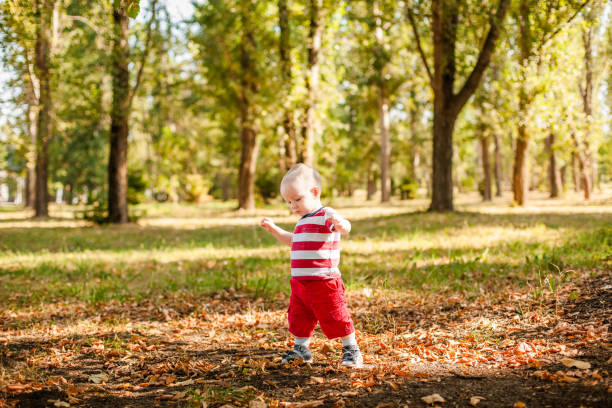 istock One-year-old little boy exploring the world in an autumn forest 2203217563