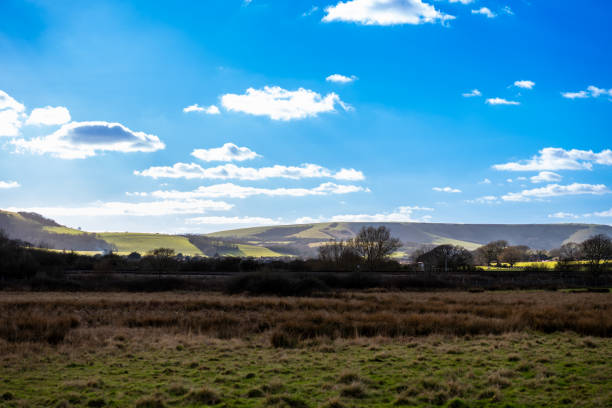 istock Distant South Downs hills with isolated highlights picked out with sunlight 2203217753
