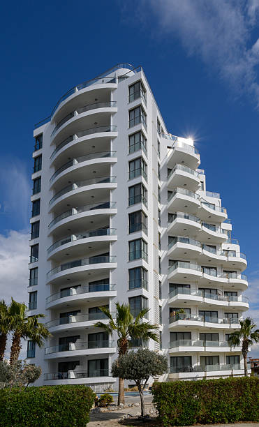 istock Modern architectural marvel stands tall against the bright blue sky with lush greenery below 2203218021