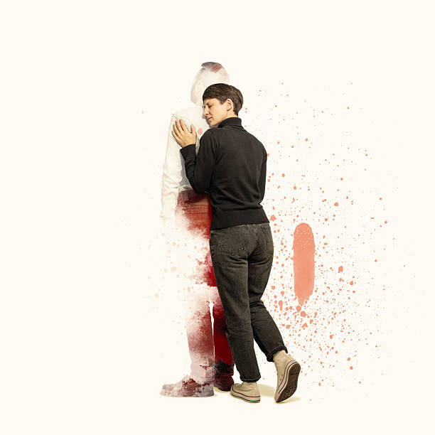 A woman is hugging a man whose silhouette is fading away.