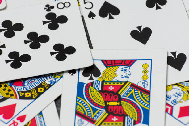 istock Scattered collection of playing cards, featuring various suits, numbers, and partial card faces. Chaotic arrangement creates a dynamic scene, symbolizing the unpredictability and thrill of card games 2203220831