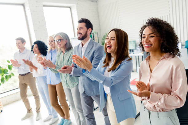 istock Group of diverse business colleagues clapping in a modern office setting with a professional and cheerful atmosphere 2203222530