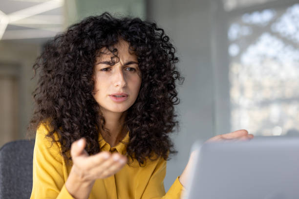 istock Dissatisfied and upset woman received a rejection and error while working with laptop. Businesswoman looking at computer screen close up, unhappy and sad 2203223158