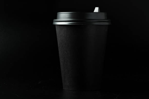 istock Black paper coffee cup on dark background 2203223573