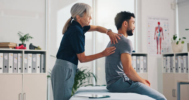 istock Chiropractor, back massage and physiotherapy on patient at consultation for spine problem or inflammation. Person, physical therapy on injury for rehabilitation or recovery of muscle damage in clinic 2203223870