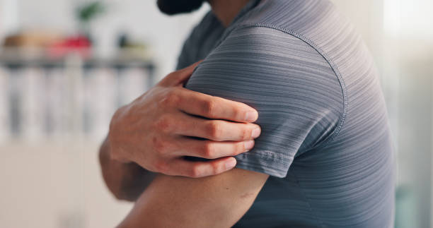 istock Pain, shoulder and man with hand on arm for problem, inflammation or arthritis disease. Person, closeup and health issue of injury, hurt or risk of weak muscle damage and osteoporosis in body 2203223923