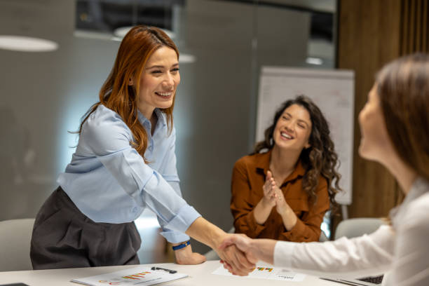 istock Businesswomen shaking hands after successful meeting 2203224242