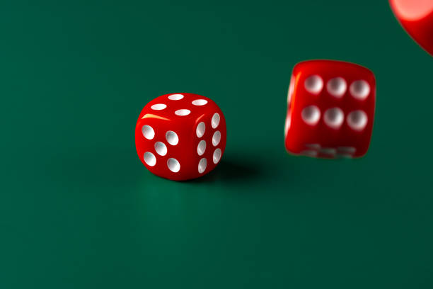 istock Red dice on green background close up 2203225049