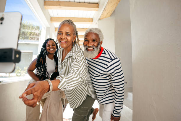 A joyful multigenerational family gathers for a fun selfie, capturing a happy moment together.