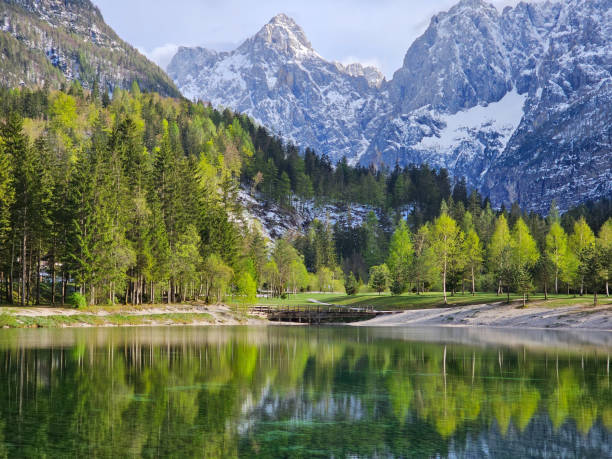istock Serene alpine landscape capturing jasna lake's mirror-like surface with julian alps towering majestically, showcasing natural beauty of kranjska gora, slovenia's triglav national park 2203227513