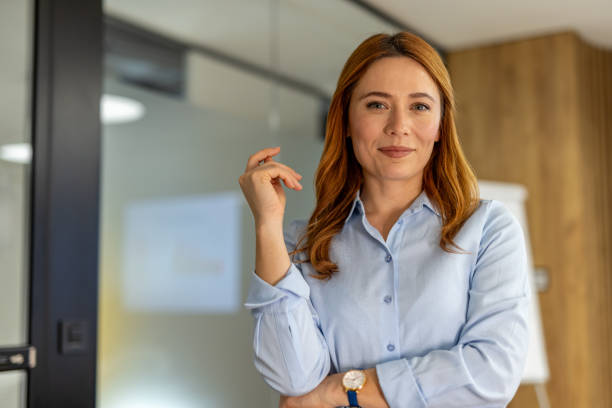 istock Confident businesswoman smiling in modern office setting 2203228732
