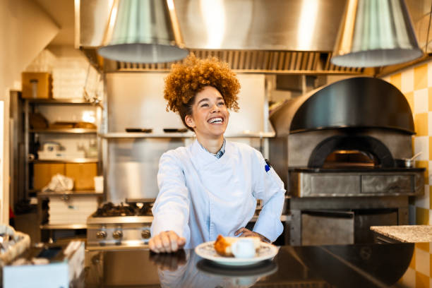 istock Proud Female Chef Showcasing Her Culinary Creation in Restaurant Kitchen 2203229922