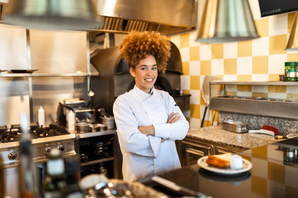 istock Smiling Woman Chef Presenting a Beautifully Plated Dish 2203229962