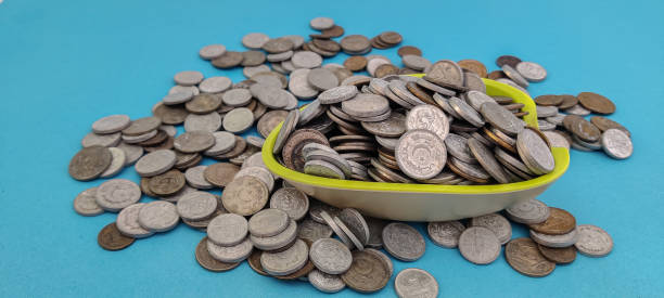 Pakistani Metal Coins in the bowl with light blue back ground