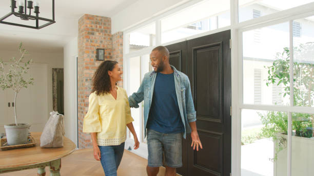 istock Couple Returning Home After Day Out Walking Through Front Door 2203230582