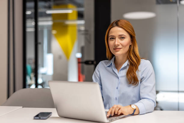 istock Businesswoman working on laptop in modern office space 2203231066