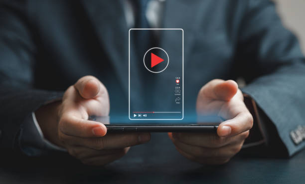 istock Person Holding Smartphone with Holographic Video Player Display Short Vertical content. 2203232623