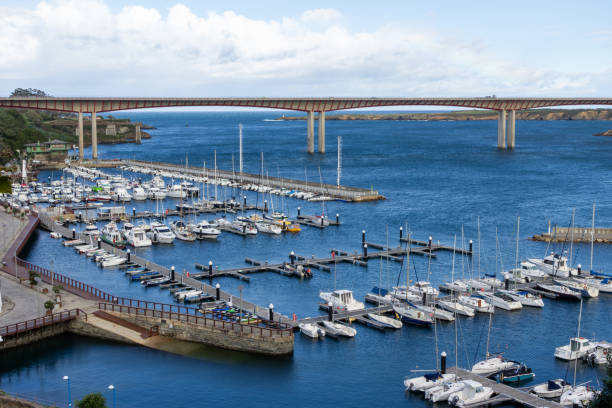 Ribadeo, Spain - October 24th 2023 - Ribadeo Port filled with various boats, surrounded by a blue sky