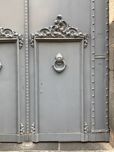 istock Grey Metal Door With Decorated Door Header and Decorative Knocker 2203234915