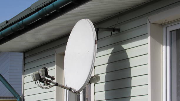istock satellite dish. white satellite dish on a house 2203235045