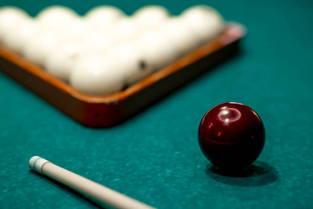 istock Russian billiards. Red and white balls are lying on a green billiard table. Spending time at home playing a hobby sports game. 2203236169