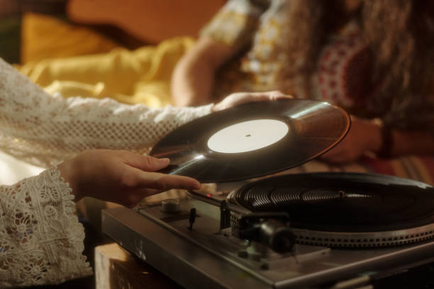 istock Spinning Vinyl Record on Turntable in Cozy Setting 2203238039