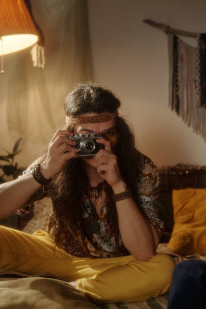 istock Taking Photo with Vintage Camera in Cozy Room Setting 2203238055