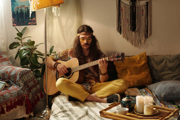 istock Playing Acoustic Guitar in Bohemian Living Room Setting 2203238103