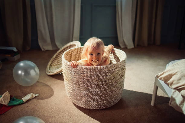 Adorable Baby Playing Inside A Wicker Basket In A Cozy Room