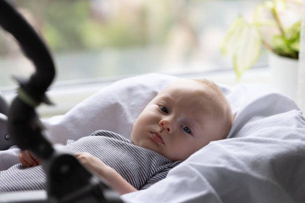 istock Baby lying in a baby high chair. 2203240141