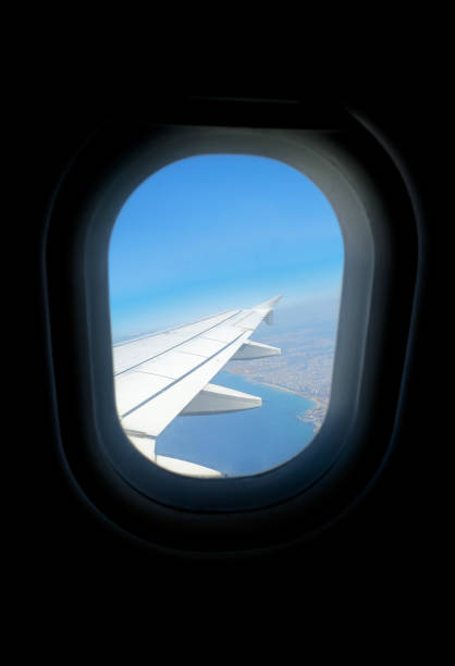 istock View from airplane window showing wing and coastal landscape during daytime flight 2203240238