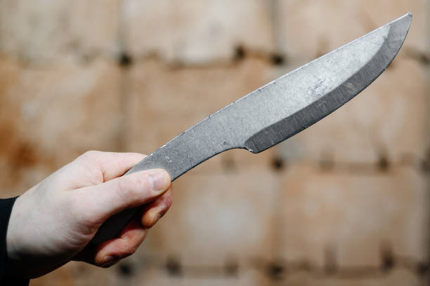 istock metal knife in wooden target 2203241147