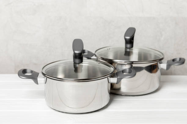 istock Stainless steel saucepan on light kitchen background. Modern saucepan. Kitchenware. Cooking pot. Cooking concept. Mockup. Space for text. Copy space. 2203242546