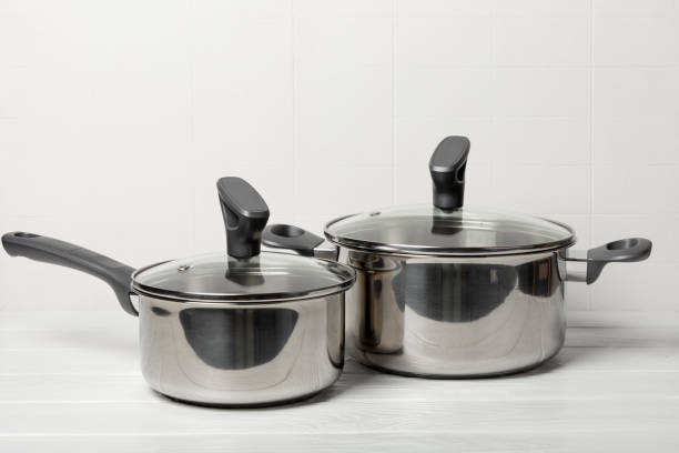 istock Stainless steel saucepan on light kitchen background. Modern saucepan. Kitchenware. Cooking pot. Cooking concept. Mockup. Space for text. Copy space. 2203242550