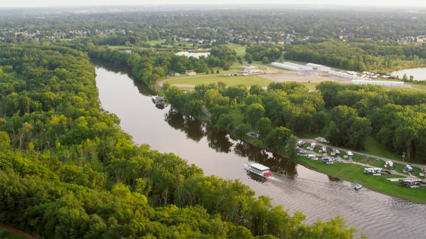 istock Scenic Riverbend with Lush Trees and Passing Boat 2203243675