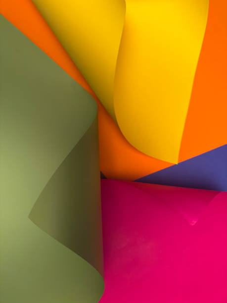 istock Abstract colored papers on blue, pink, green, yellow and orange background. 2203244210