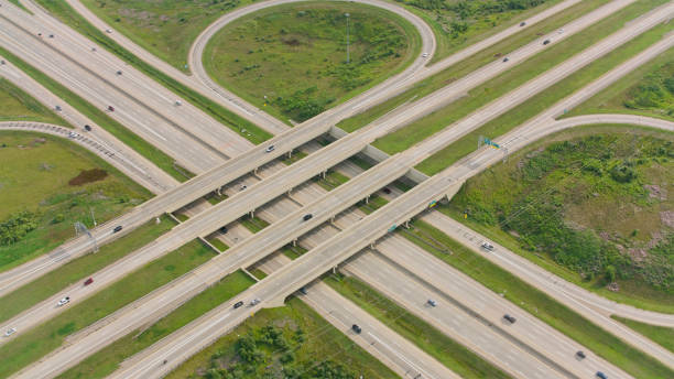 Aerial drone looking down view above Crossing roads and intersections of mass development in Austin , Texas , USA - roads , highways , interchange