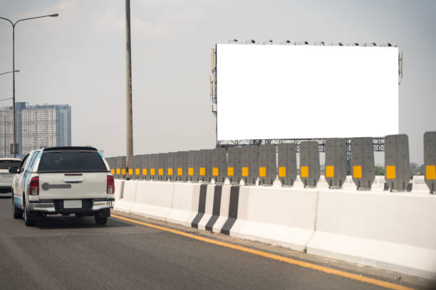 Mockup of a freeway billboard with white space for advertising. Clipping path. Blank billboard at blue sky background. Blank billboard on the highway.