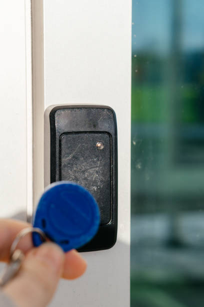 istock A person uses an RFID key fob to access a secure door via an electronic card reader, symbolizing modern security technology. 2203248498